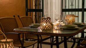 A dining table set with glassware, plates, and a candle holder. - APARTMENT SEEVIEW ON THE BEACH PARKING ALL INCLUSIVE TORROX NERJA MALAGA SPAIN (Torrox Costa)