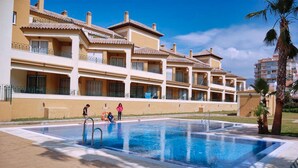 A hotel with a swimming pool, multiple balconies, and a clear sky. - APARTMENT SEEVIEW ON THE BEACH PARKING ALL INCLUSIVE TORROX NERJA MALAGA SPAIN (Torrox Costa)