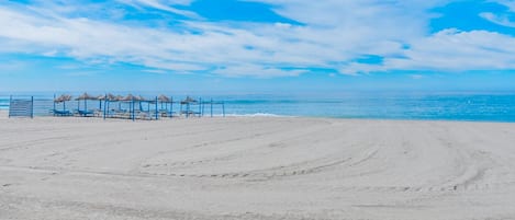 On the beach, sun loungers, beach towels