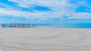 On the beach, sun-loungers, beach towels