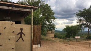 A building with a sign reading "MAN" and a wooden fence. - Paje River Camp (Paje)