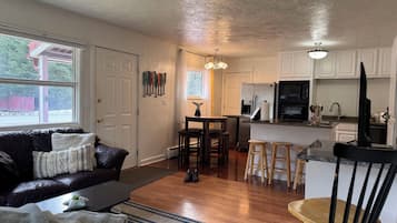 A compact living space with a kitchen, a dining area, and a seating area.