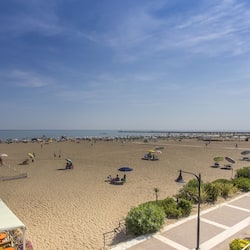 On the beach, sun-loungers, beach umbrellas, beach bar