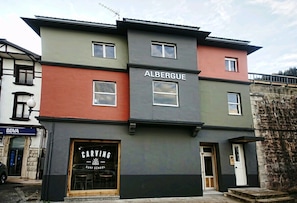 A multi-story building with the name "ALBERTGUE" on the facade.
