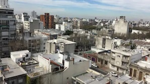 A densely packed urban area with various buildings, including high-rise and low-rise structures.