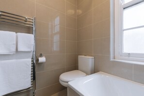 Bathtub, hair dryer, towels, soap