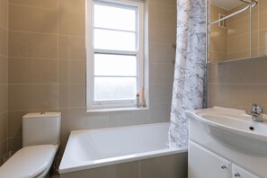 Bathtub, hair dryer, towels, soap