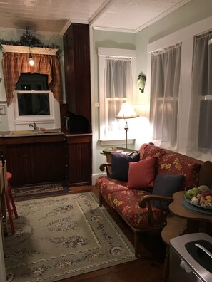 Relax in this inviting living room with a sofa, table, and plant.