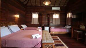A room with two beds, a bench, a desk, and a television. - Atins Charme Chales (Barreirinhas)