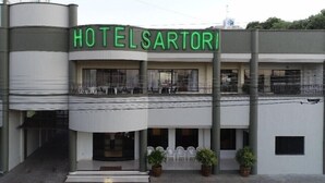 A building with a sign reading "HOTEL SARTORI".