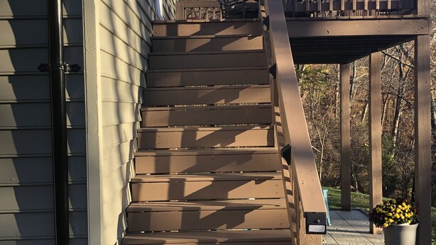 A wooden staircase leading to a deck with a railing, a potted plant, and a metal chair. - Pete's Place: Forest retreat near wineries, Blue Ridge School, and Shenandoah NP (Stanardsville)
