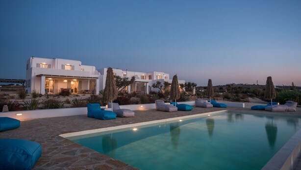A modern villa with a swimming pool, outdoor seating, and a landscaped garden. - White Sands Smile  · Fabulous pool villa, steps fr (Xifara)