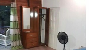 A bedroom with a bed, a dresser, a mirror, and a fan. - Tranquil and Peaceful Parlatuvier (Parlatuvier)