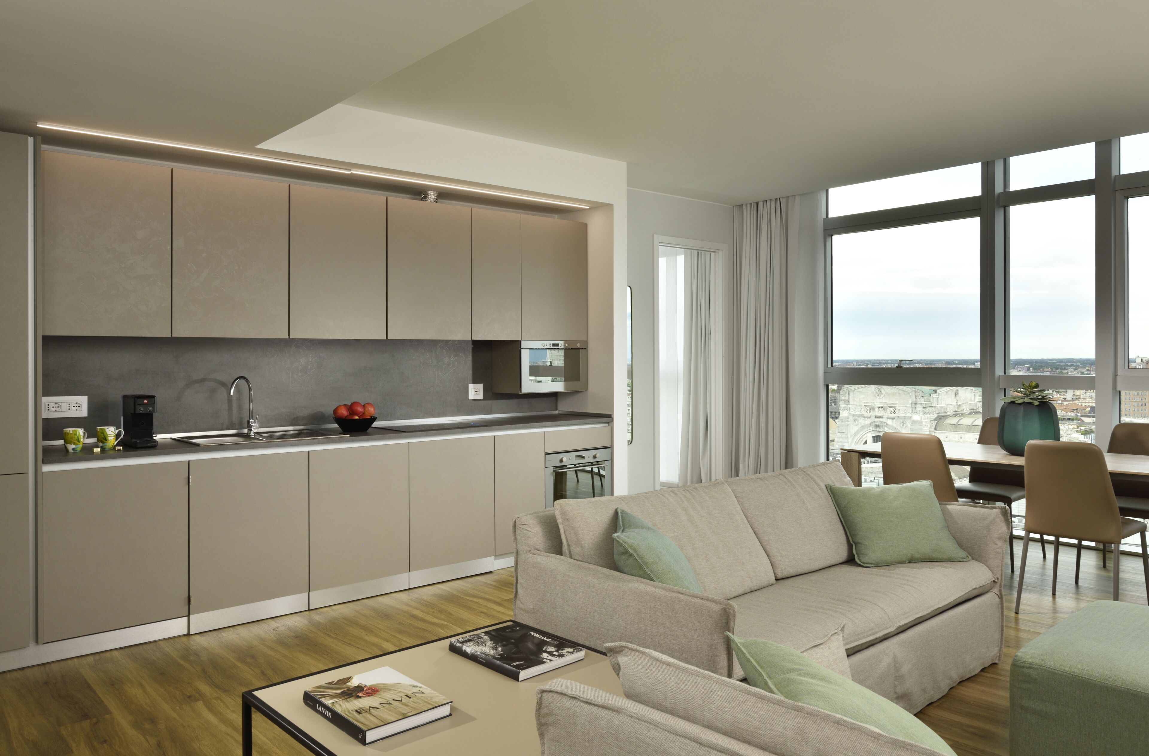 A modern apartment with a kitchen, dining area, and living room.