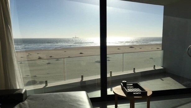 A balcony with a view of the beach and ocean. - 32  Bay View Suites  (Langstrand)