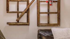 A rustic wall with a wooden grid pattern, a hanging lamp, and a Santa Claus decoration.