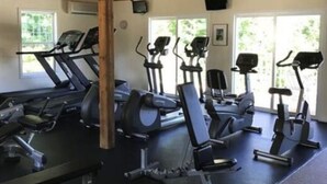 A gym with treadmills, elliptical machines, and stationary bikes. - Cute and Comfy Cottage - 1 Mile to Wells Beach & 3 Miles to Ogunquit Beach! (Wells)