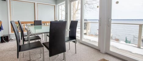 Enjoy meals and conversations around the large table, surrounded by a view of the water through the large windows.