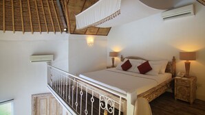 A bedroom with a bed, bedside lamps, a nightstand, and a balcony with a railing. - 1BR Lagoon Villa in Seminyak, 35sqm Pool view, 5 mnts walk to shopping area (Kuta)
