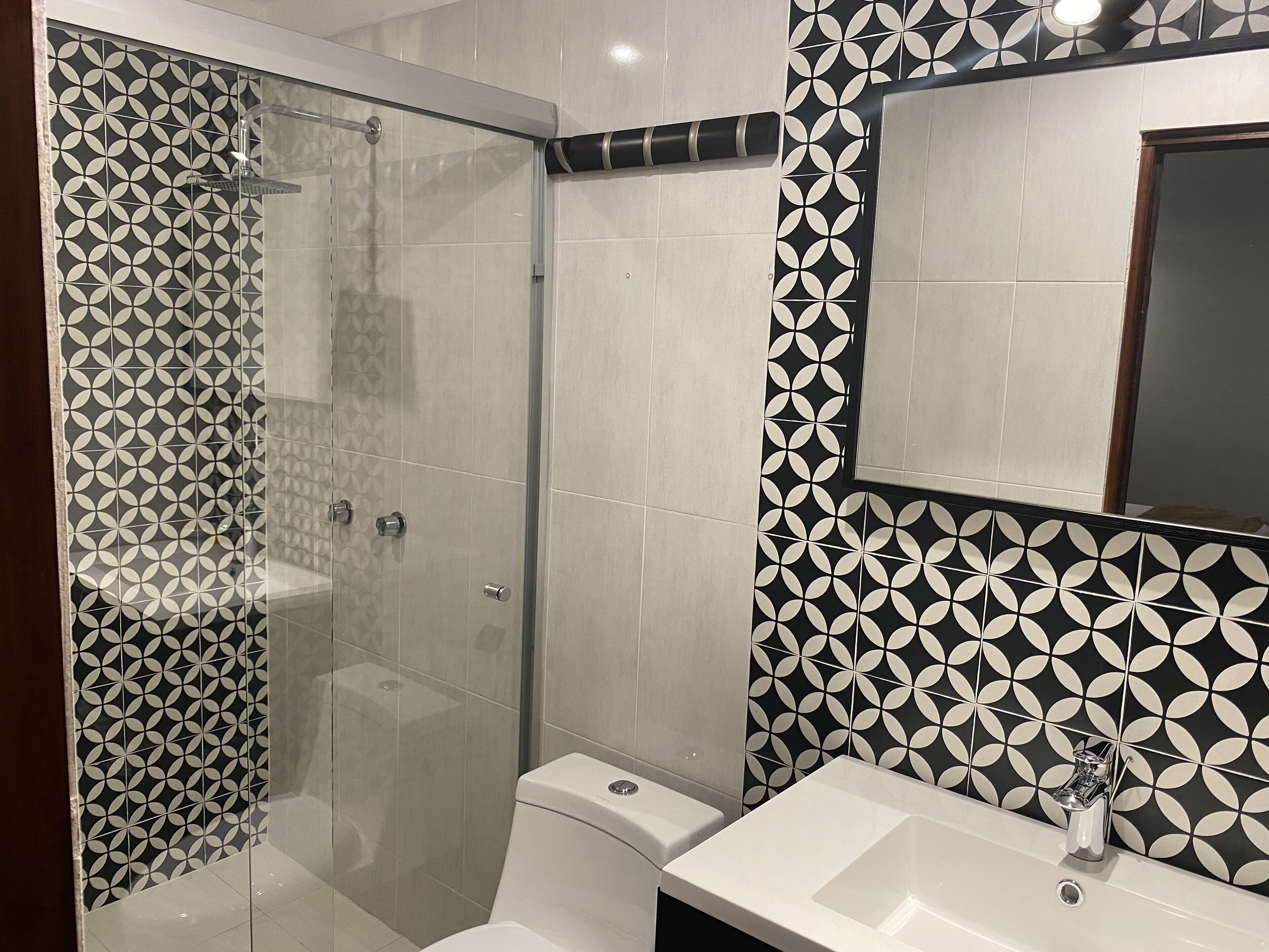 deluxe room, 2 double beds | bathroom | shower, towels, soap, shampoo