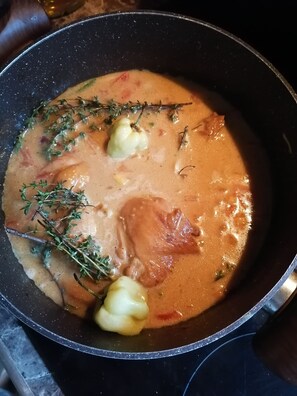 A pot of creamy soup with herbs and chunks of meat. - Monteverde Eco Love (Monteverde)