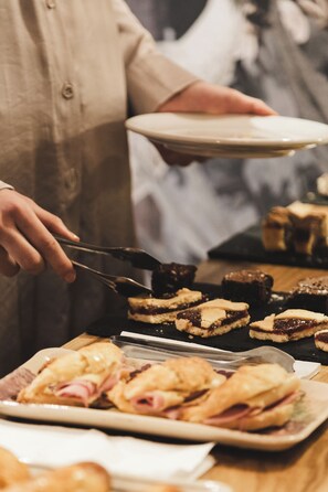 Guests can enjoy a selection of sweet treats, including pastries and baked goods, served by our friendly staff.