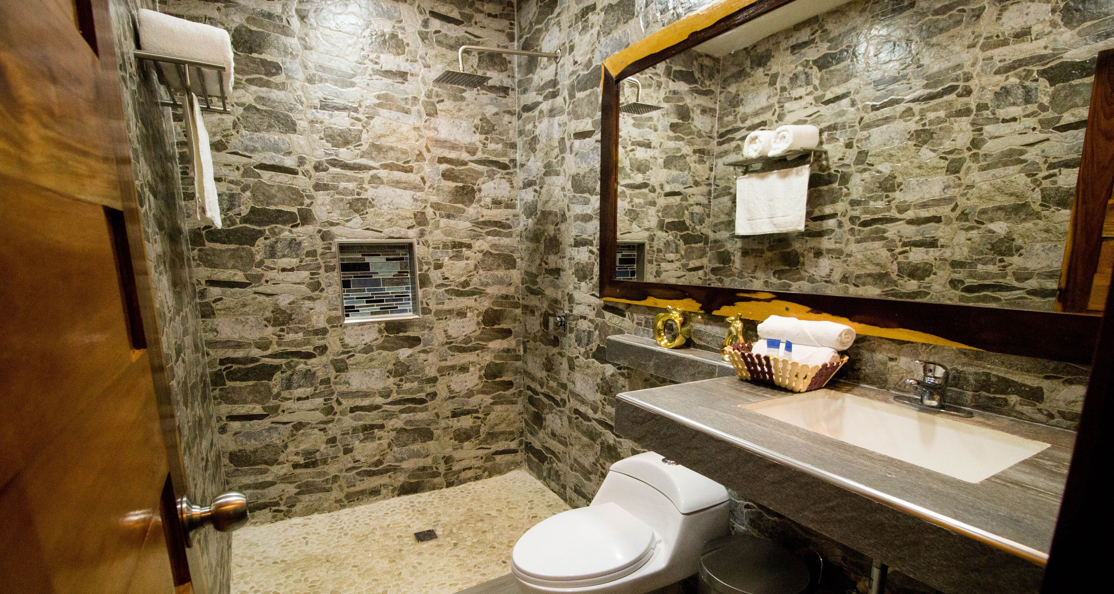 luxury room, 2 queen beds | bathroom | shower, towels, soap, shampoo