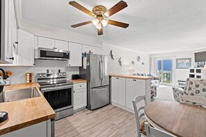 Fridge, microwave, oven, stovetop - Experience Breathtaking Beach and Pool Views at this Shore Drive Condo (Myrtle Beach)
