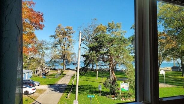 A residential street with houses, a sidewalk, and a sign for 'Shore Dr.' - Rye Beach Lake Front Home near Cedar Point (Huron)