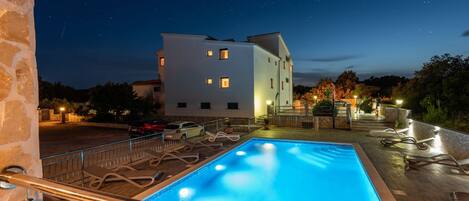 A heated pool, pool loungers
