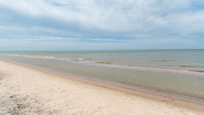A beach with clear skies and calm waters. - Private Cherry Beach Pool House with large heated pool & hot tub!  (Three Oaks)