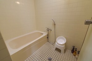 A bathroom with a bathtub, toilet, and shower. - Pine House in Araha (Chatan)