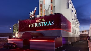 A hotel with a prominent "HOTEL CHRISTMAS" sign, a modern architectural design, and a parking area. - Hotel Christmas (Inazawa)