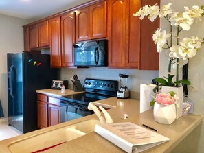 Een oven, een kookplaat, een vaatwasser, kookgerei, borden en bestek