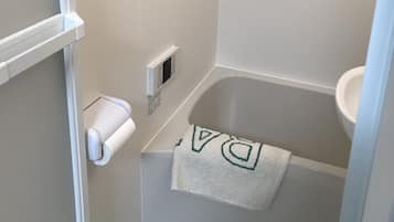 Separate tub and shower, free toiletries, hair dryer, slippers