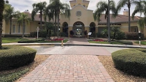 A building with a symmetrical facade, arched entrance, and a central clock tower. - Tideview 166 · NEW Ultra Modern & Super Clean 3 Full Suites (Orlando)