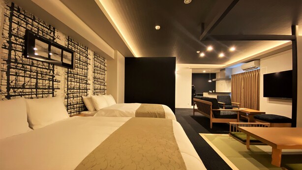 A modern hotel room with a large bed, a desk, a chair, a TV, and a wall with abstract art. - Randor Residential Hotel Fukuoka Annex (Fukuoka)