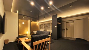 A modern hotel room with a wooden chair, a small table, a bed, and a mirror. - Randor Residential Hotel Fukuoka Annex (Fukuoka)
