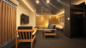 A hotel room with a TV, two sofas, a bed, and a bathroom. - Randor Residential Hotel Fukuoka Annex (Fukuoka)