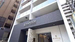 A modern building with a prominent sign for 'RANDOR HOTEL & RESIDENCE'. - Randor Residential Hotel Fukuoka Annex (Fukuoka)
