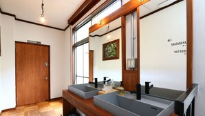 A bathroom with two sinks, a wooden vanity, a mirror, and a door labeled "KAYAGATAKE". - nirasakiyaSTAY (Nirasaki)