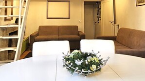 A dining area with a white table, a chandelier, and a decorative centerpiece. - Navona Loft Terrace, splendid apartment with terrace in the historic center (Roma)