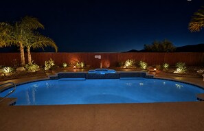 A swimming pool with a wooden deck and palm trees. - Salt Water Pool & Spa with Mountain Sunset Views! (Desert Hot Springs)