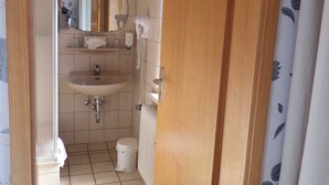 A bathroom with a sink, mirror, and toilet. - Double room 2 - Pension Harzer Winkel (Bad Sachsa)