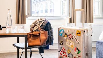 A room with a suitcase, a handbag, and a pair of boots.