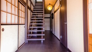 A narrow hallway with a wooden staircase leading to a landing. - ID STAY Kawaguchiko 3 (Fujikawaguchiko)