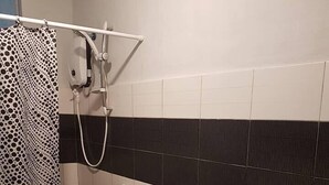 A bathroom with a toilet, bidet, and sink. - Batanes Casa Feliciano (Basco)