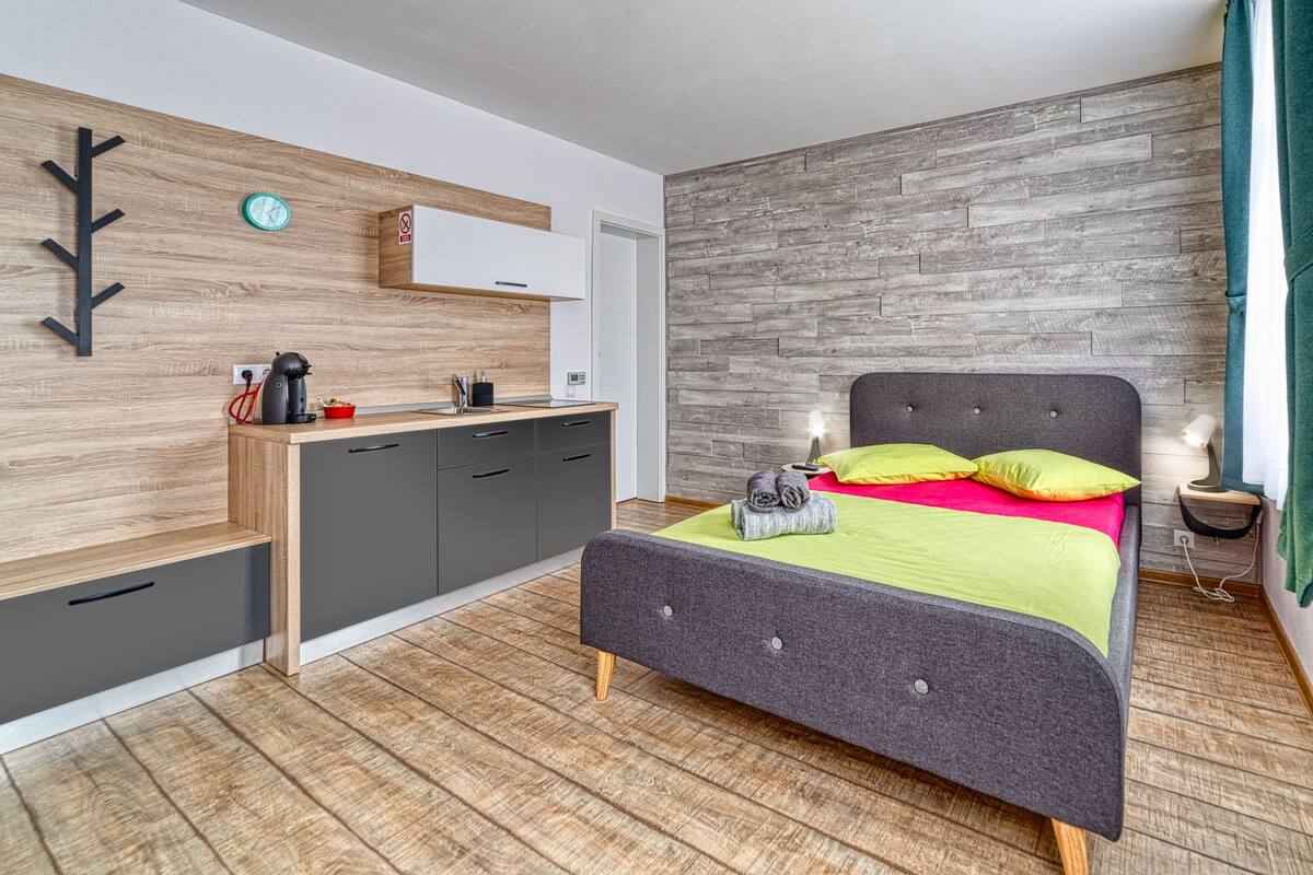 A bedroom with a bed, bedside table, and a built-in wardrobe.