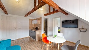 A modern kitchen with wooden cabinets, a sink, and a countertop. - T House (Sibiu)