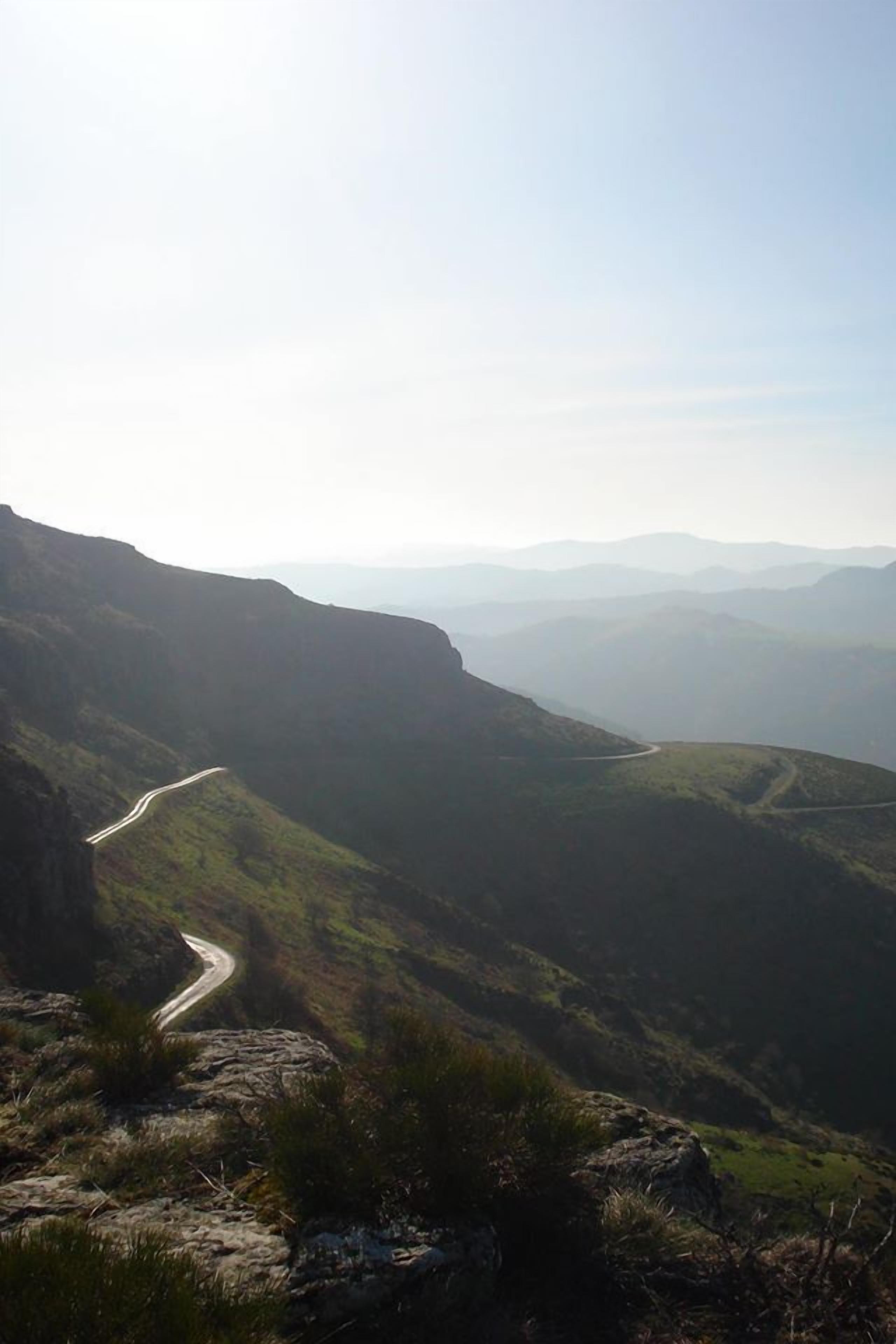 A winding road through a mountainous landscape.